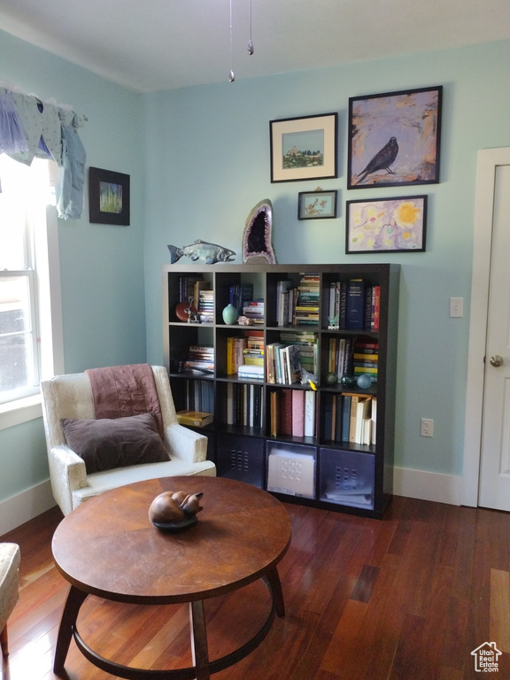 Sitting room with baseboards and wood finished floors