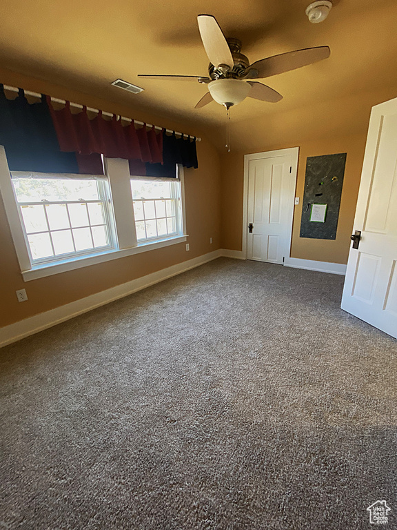 Unfurnished bedroom featuring baseboards, visible vents, and ceiling fan