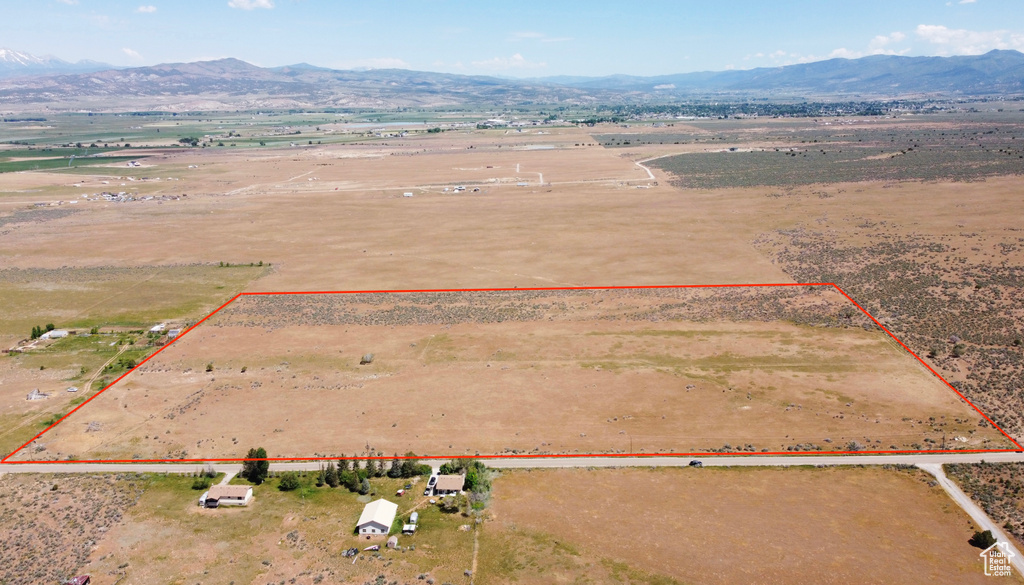 Overview of rural landscape with a mountainous background and property parcel outlined