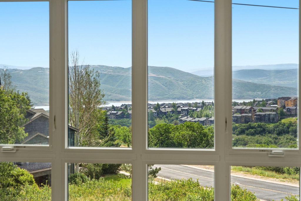 Expansive window framing a distant lake and mountainous terrain