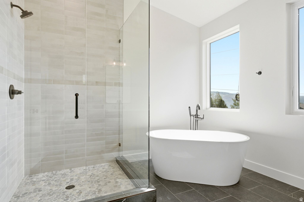 Freestanding soaking tub with floor-mounted faucet