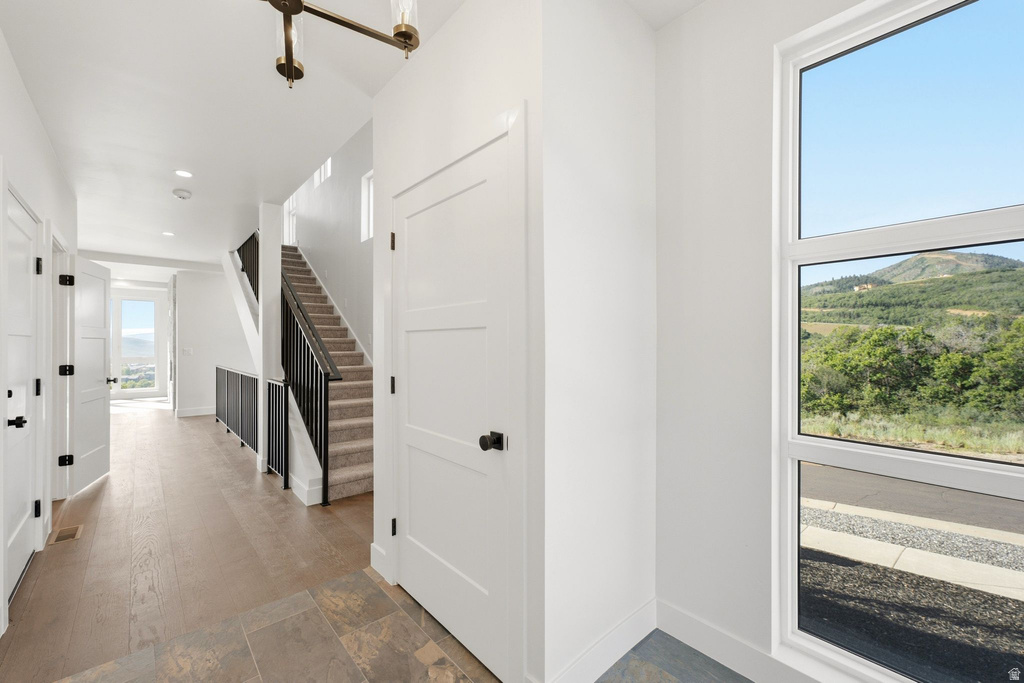 Bright entryway featuring a large picture window with a distant mountainous landscape