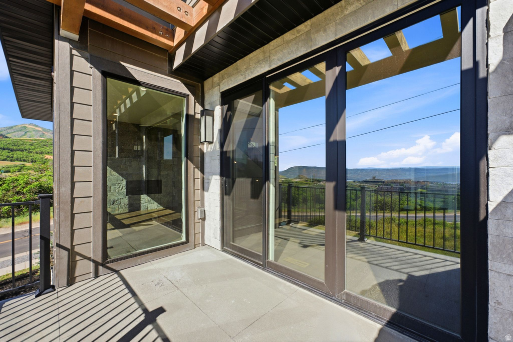 Exterior patio featuring a concrete surface and black metal railing