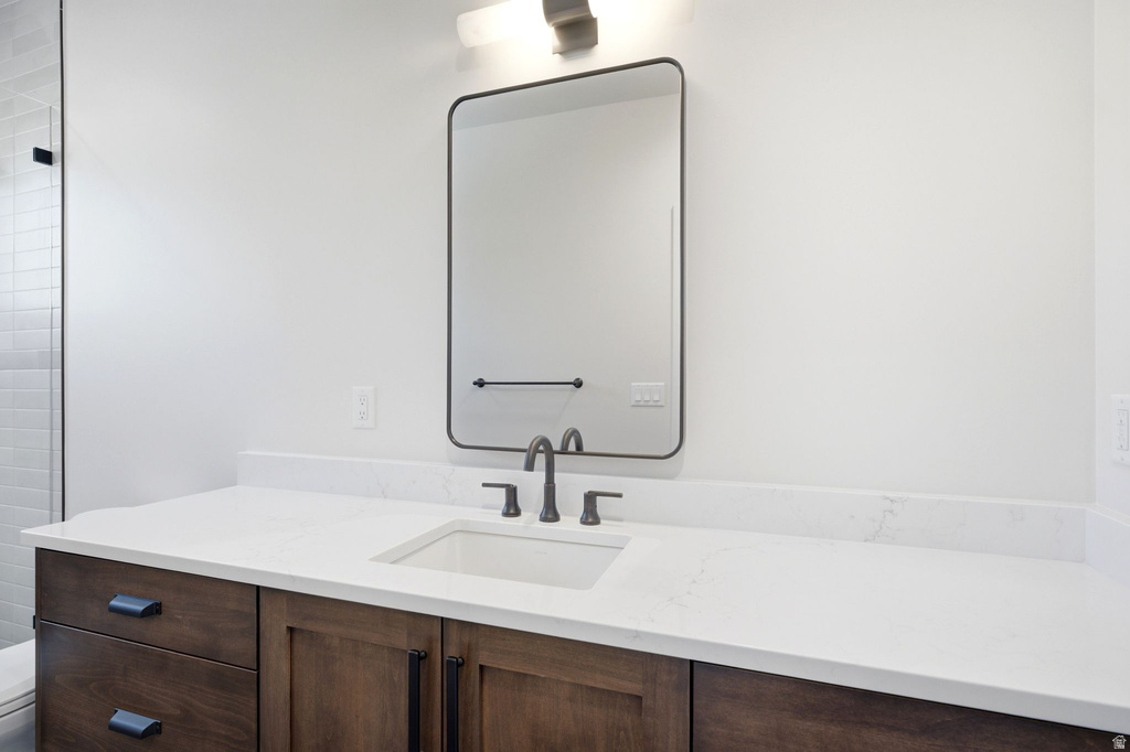 Modern vanity featuring a rectangular undermount sink, matte black faucet, and white countertop