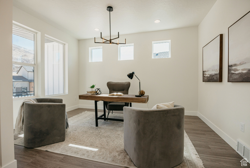 Home office with recessed lighting, wood finished floors, visible vents, and baseboards