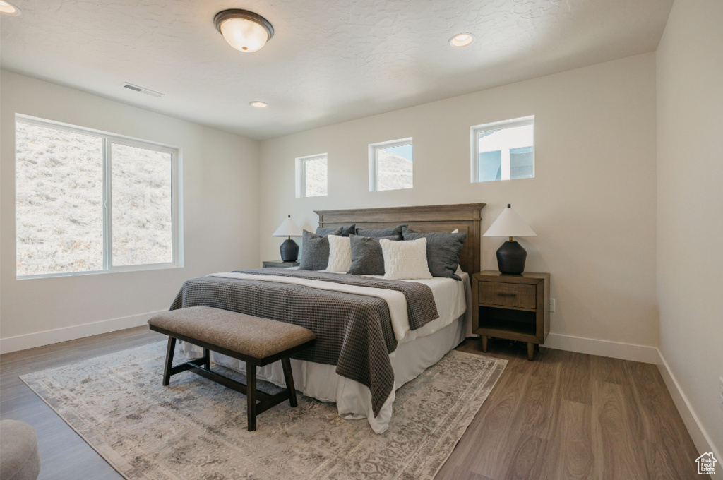 Bedroom featuring visible vents, recessed lighting, baseboards, and wood finished floors