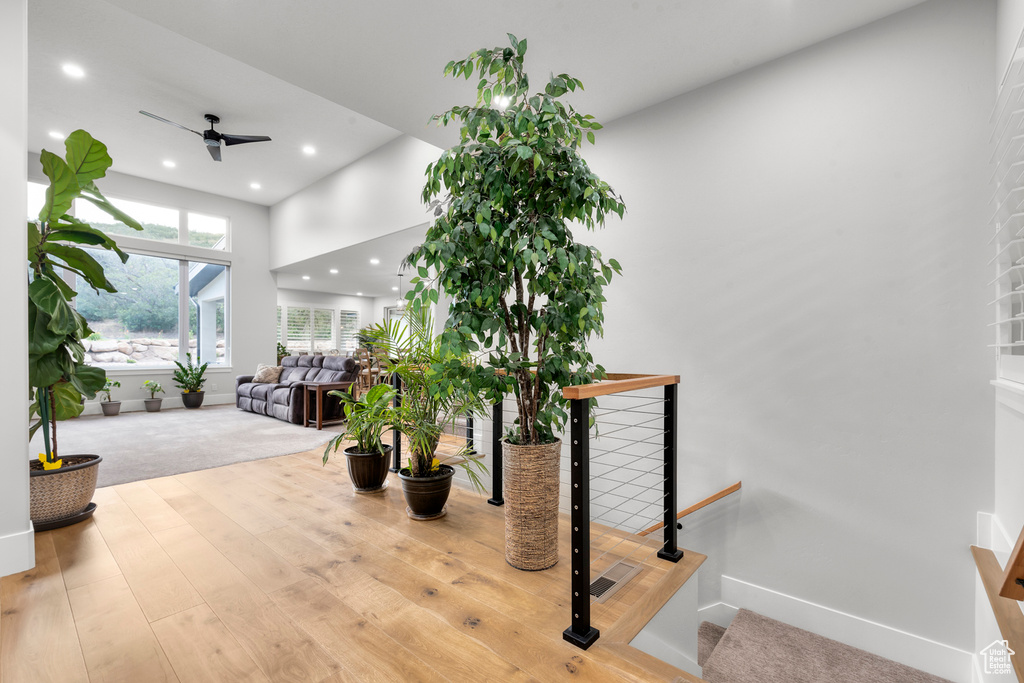 Interior space featuring visible vents, a ceiling fan, recessed lighting, a high ceiling, and baseboards