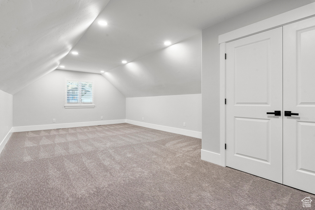 Bonus room featuring recessed lighting, baseboards, lofted ceiling, and carpet flooring