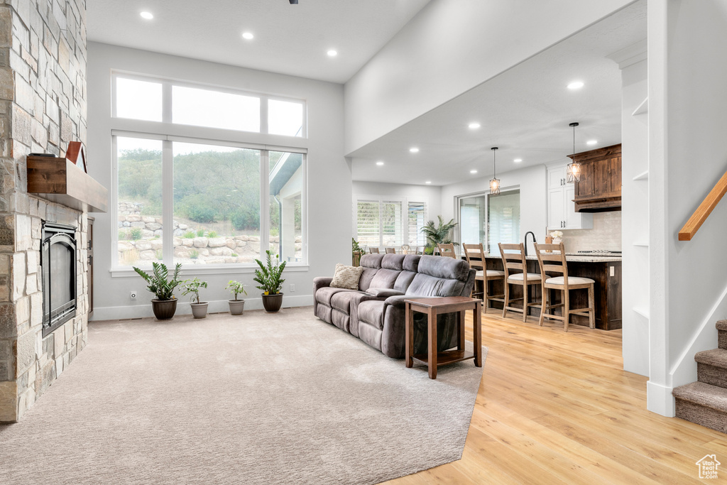 Living room featuring stairway, recessed lighting, a fireplace, and baseboards