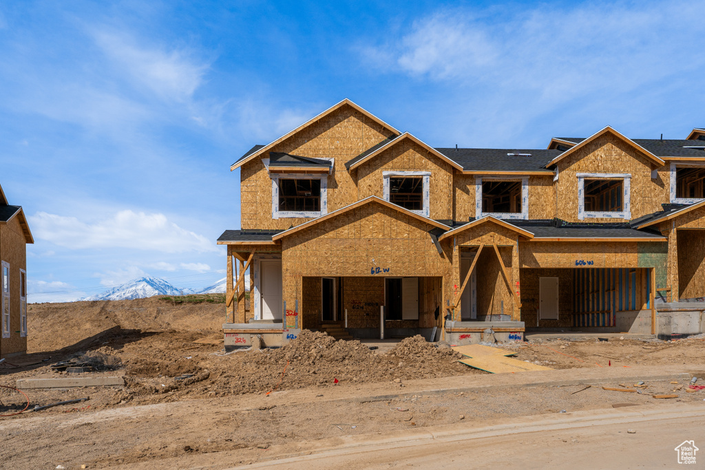 Unfinished property featuring a porch and a mountain view