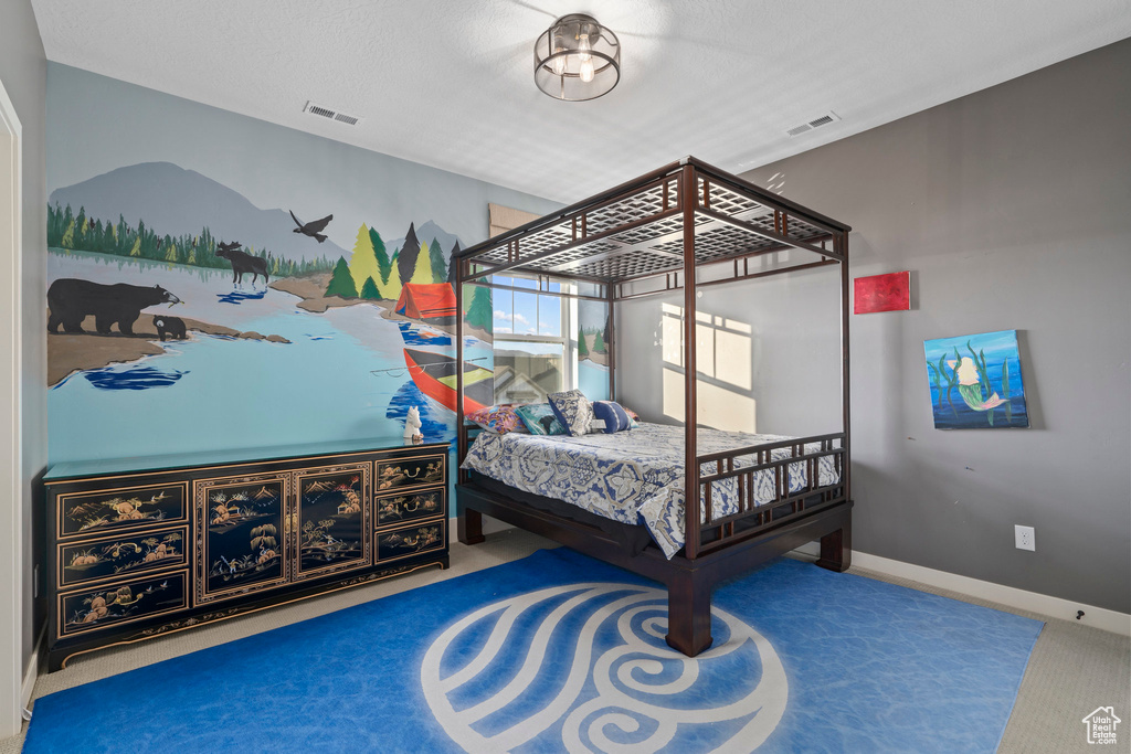 Carpeted bedroom with visible vents and baseboards