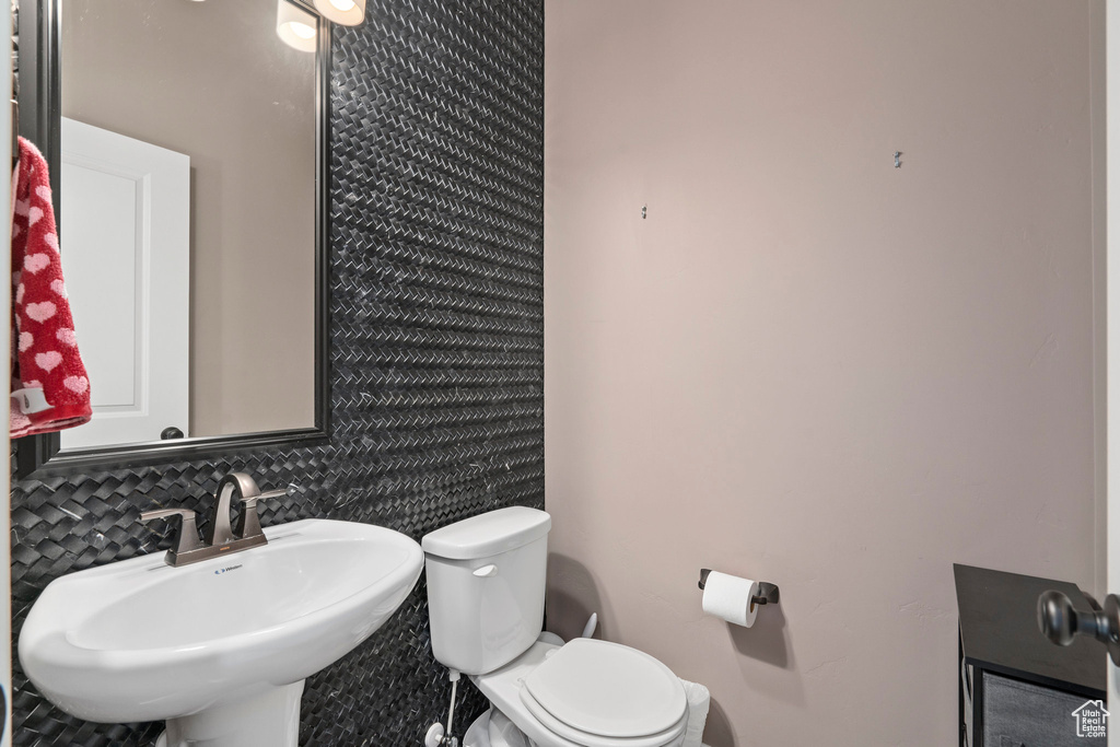 Half bathroom featuring toilet and a sink