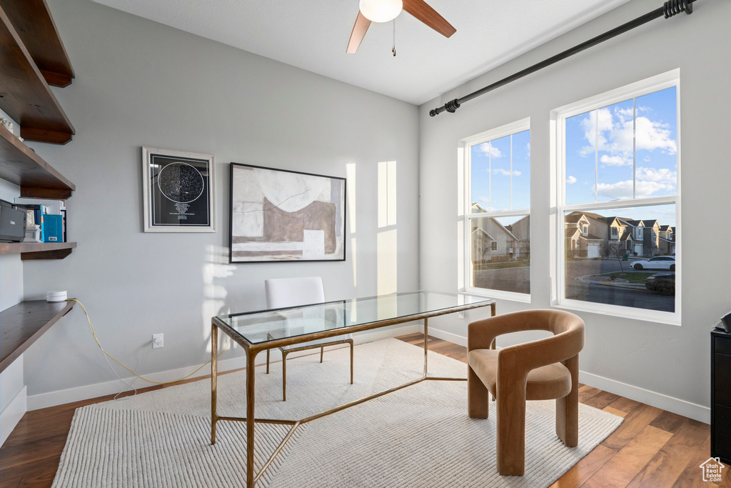 Home office featuring a ceiling fan, wood finished floors, and baseboards