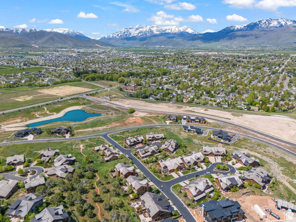 View of property location featuring a water and mountain view and nearby suburban area