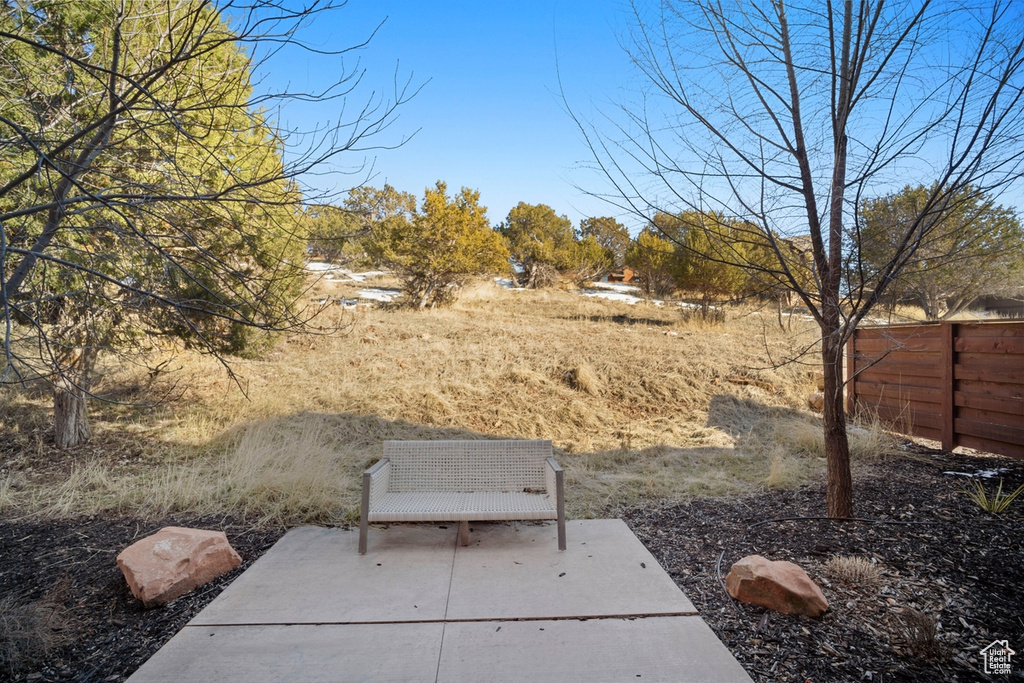 View of yard with a patio and fence