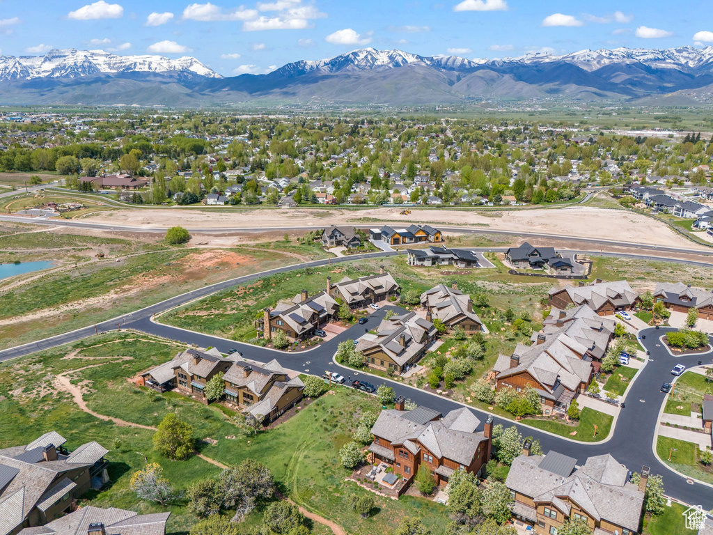 Aerial view of property's location featuring nearby suburban area and a mountainous background