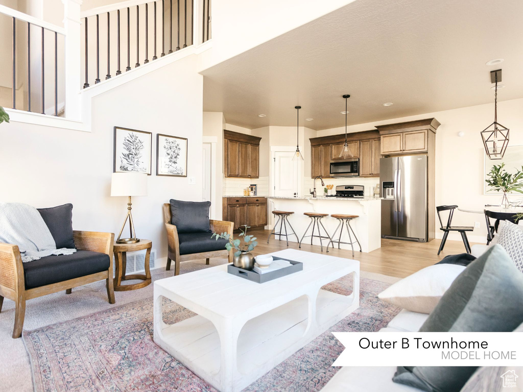 Living room with recessed lighting and light wood-style floors