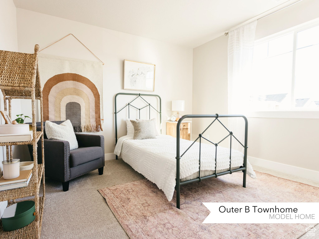 Bedroom featuring baseboards and carpet