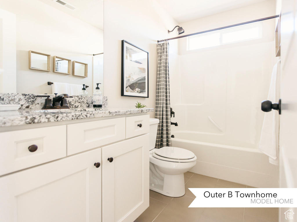 Bathroom with visible vents, toilet, tile patterned floors, shower / bath combination with curtain, and vanity