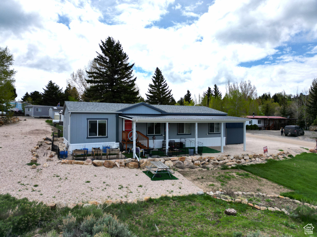 Ranch-style house featuring covered porch