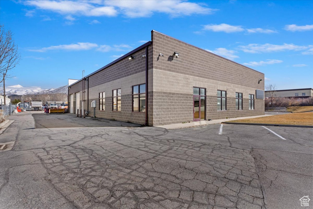 View of property featuring uncovered parking and a mountain view