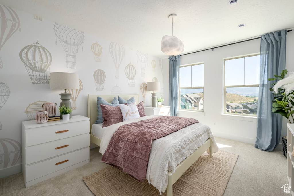 Bedroom featuring light colored carpet and baseboards