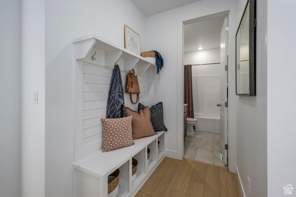 Mudroom featuring baseboards and light wood-type flooring