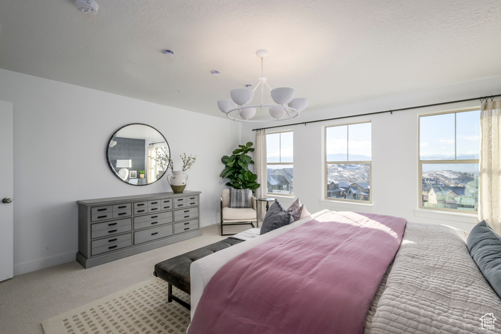 Bedroom featuring carpet floors and an inviting chandelier