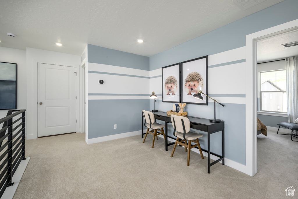 Carpeted office space with visible vents, recessed lighting, and baseboards