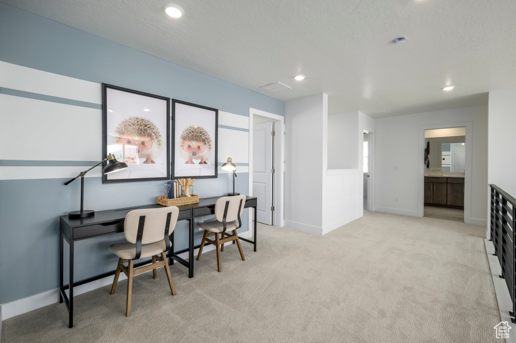 Office featuring a textured ceiling, recessed lighting, baseboards, and light carpet