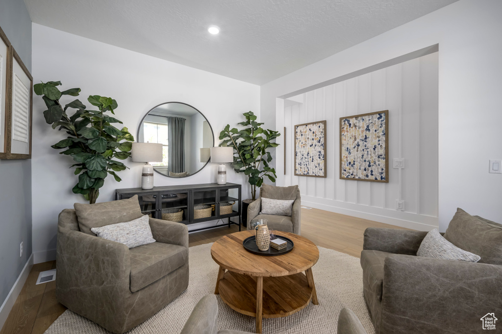 Interior space with wood finished floors, visible vents, and baseboards