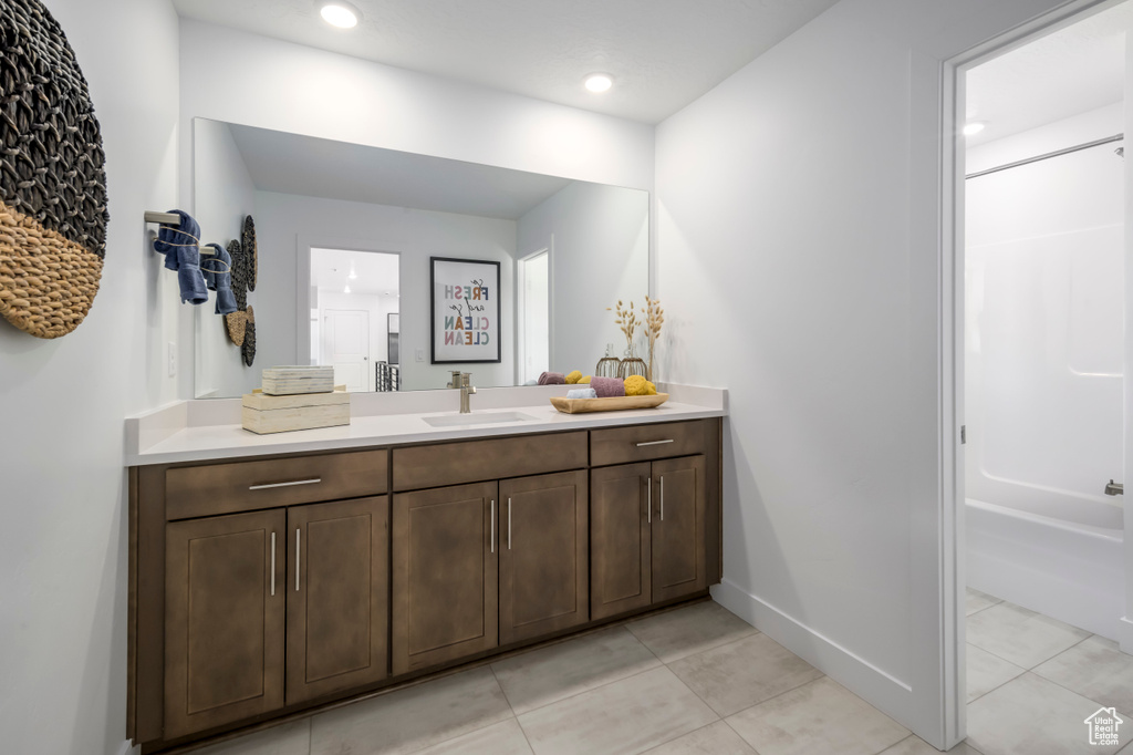 Bathroom featuring recessed lighting, baseboards, vanity, and tile patterned flooring