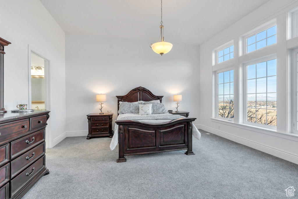 Bedroom featuring light colored carpet and baseboards