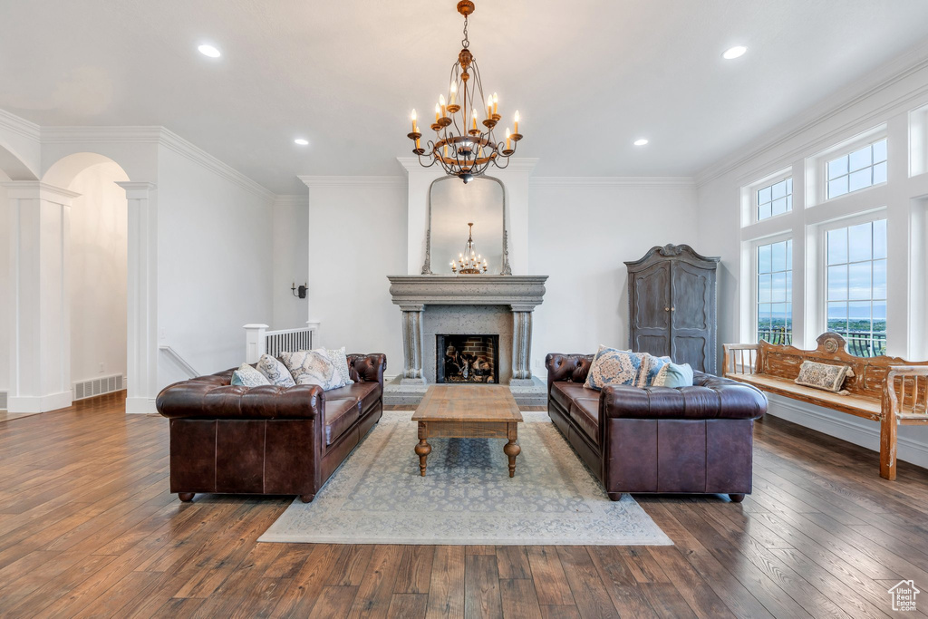 Living room with visible vents, recessed lighting, hardwood / wood-style floors, and a notable chandelier