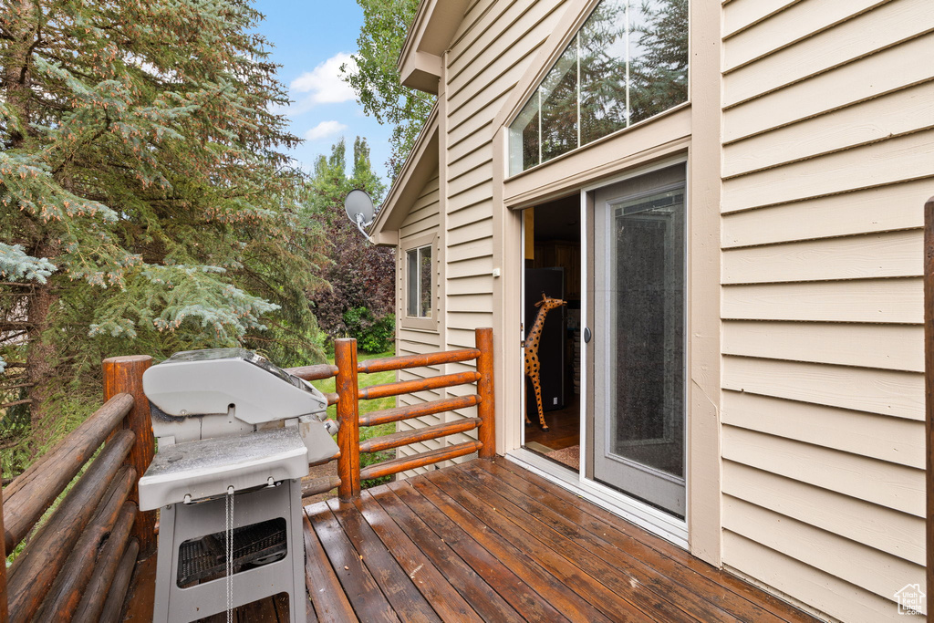 Wooden terrace featuring area for grilling