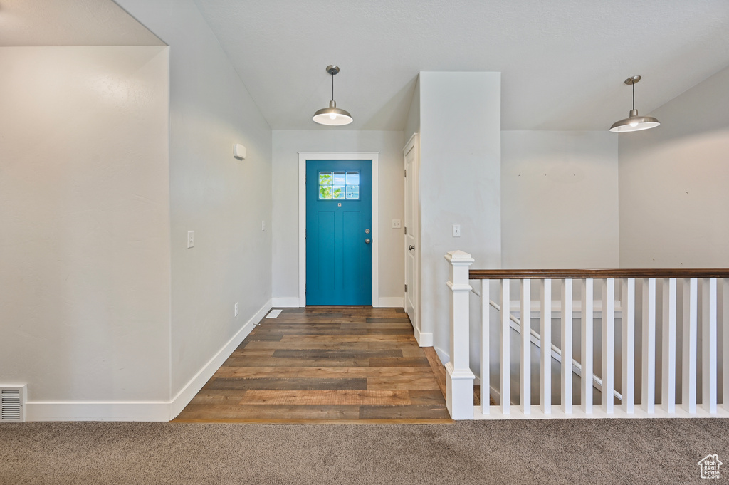 Entryway featuring baseboards and carpet flooring