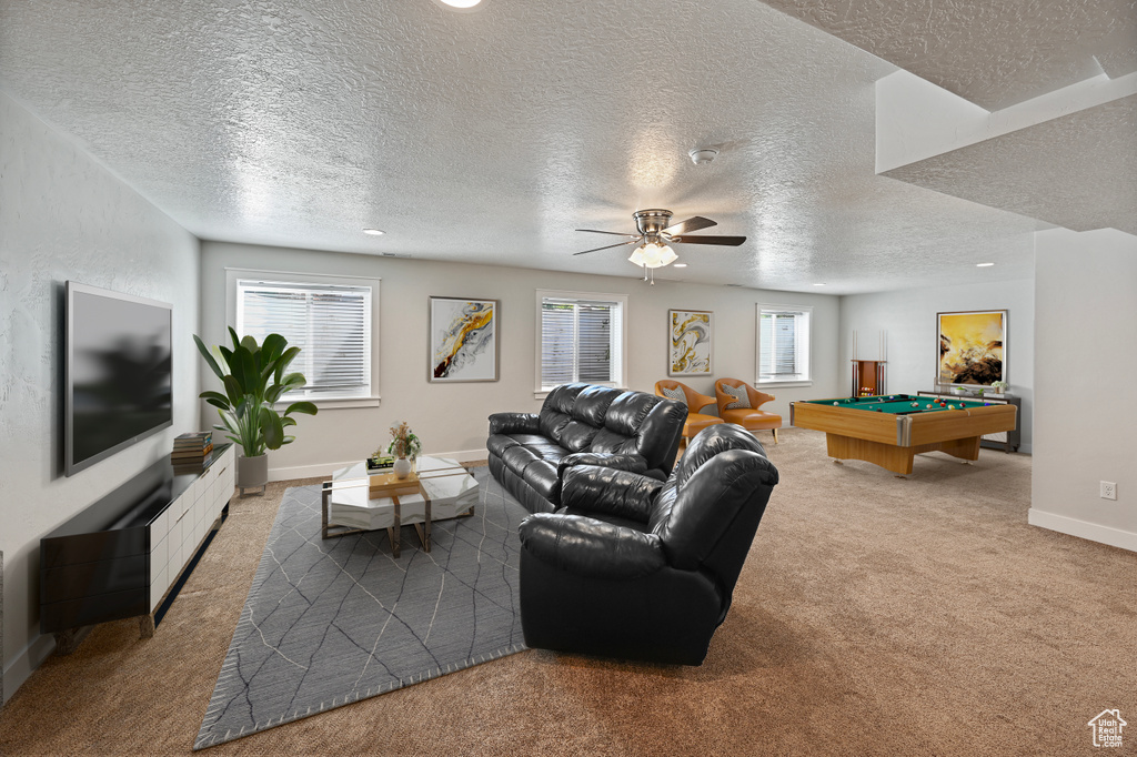 Living room with carpet floors, billiards, a textured ceiling, a ceiling fan, and baseboards