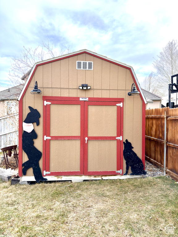 View of shed featuring fence