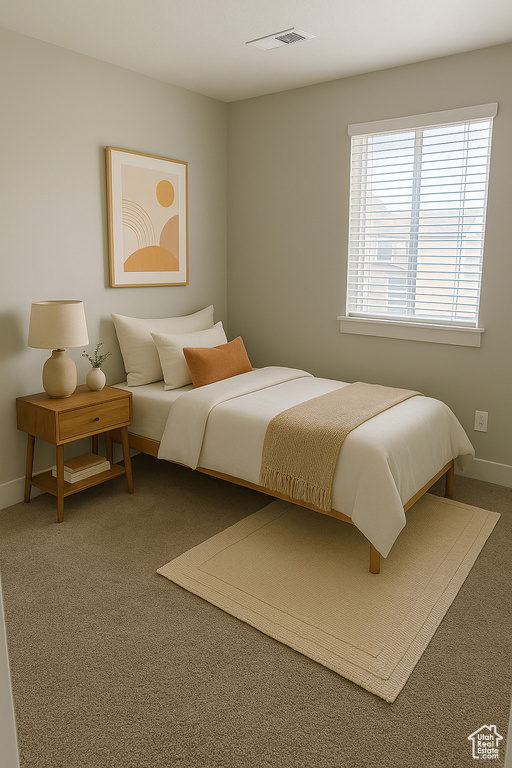 Carpeted bedroom featuring baseboards and visible vents
