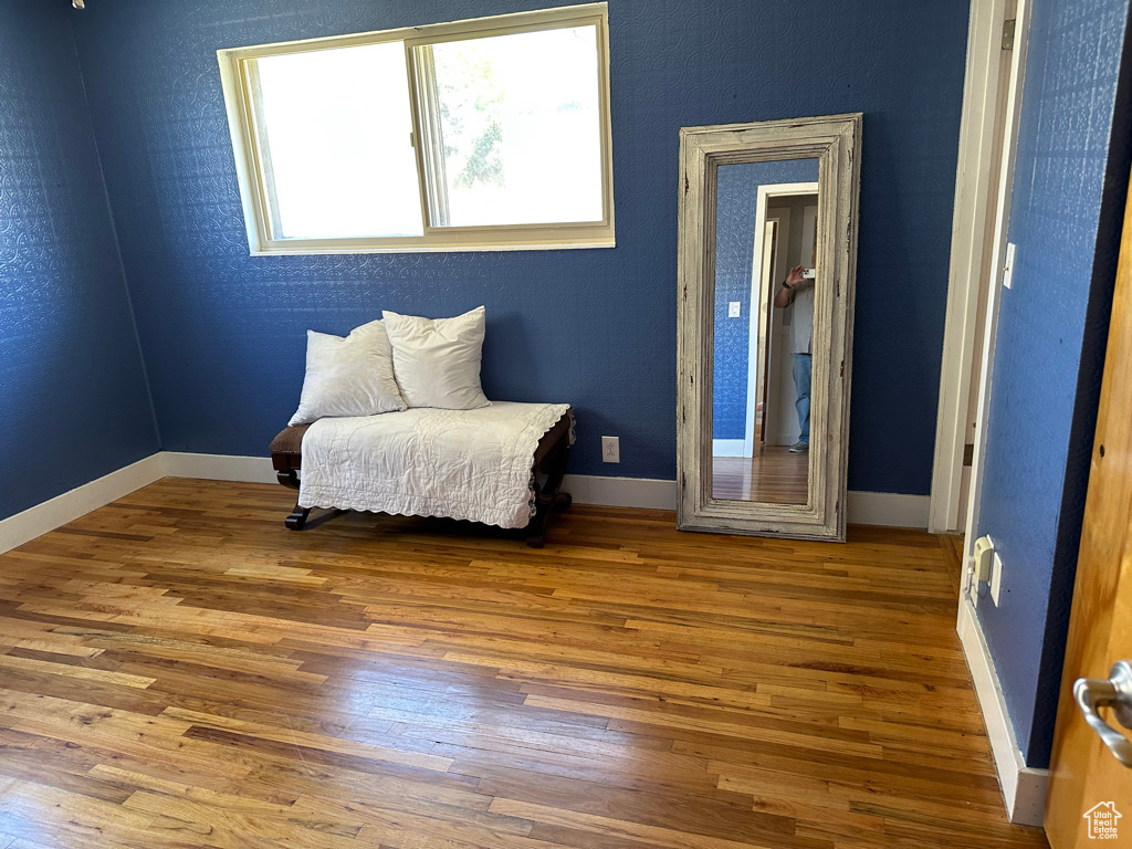 Living area with wood finished floors and baseboards