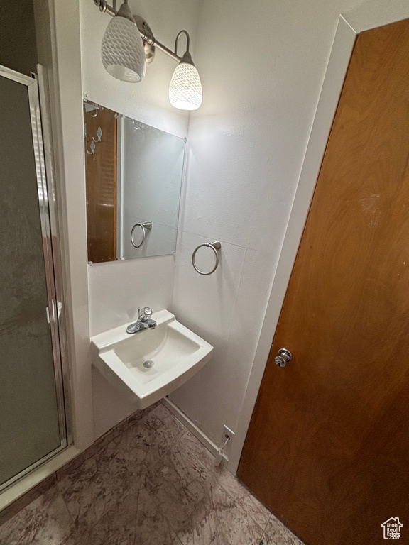 Bathroom with a shower stall and a sink