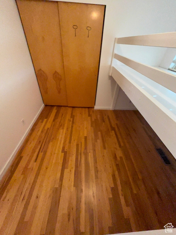 Unfurnished bedroom featuring visible vents and light wood-style floors