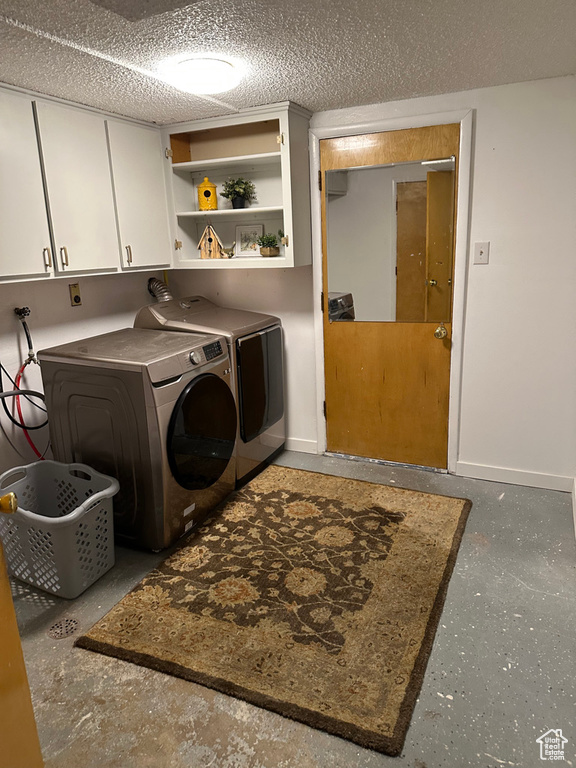 Laundry room with cabinet space, washing machine and clothes dryer, and baseboards
