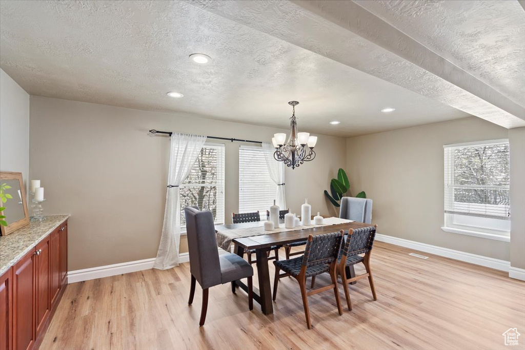 Dining area featuring an inviting chandelier, recessed lighting, baseboards, and light wood finished floors