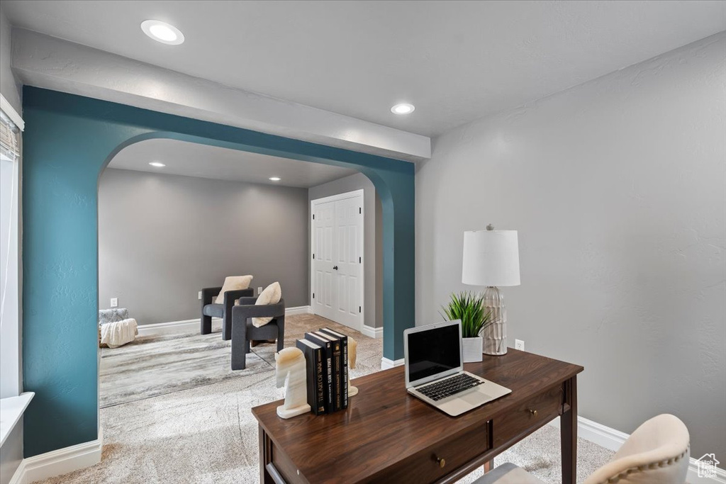 Carpeted office featuring recessed lighting, baseboards, and arched walkways
