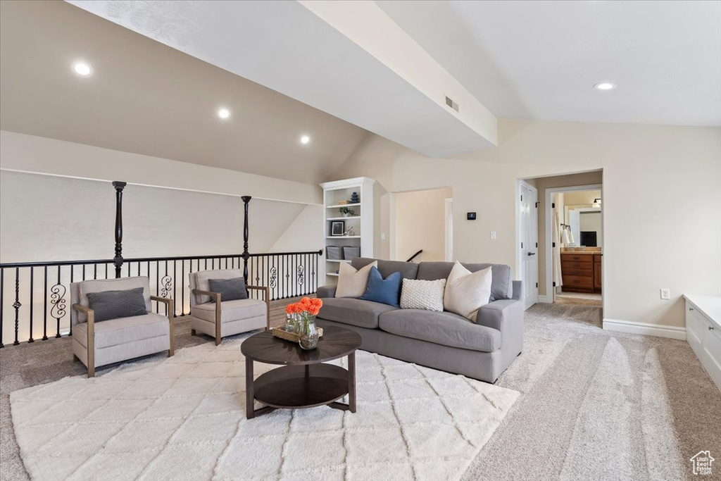 Living area with visible vents, baseboards, light colored carpet, vaulted ceiling, and recessed lighting
