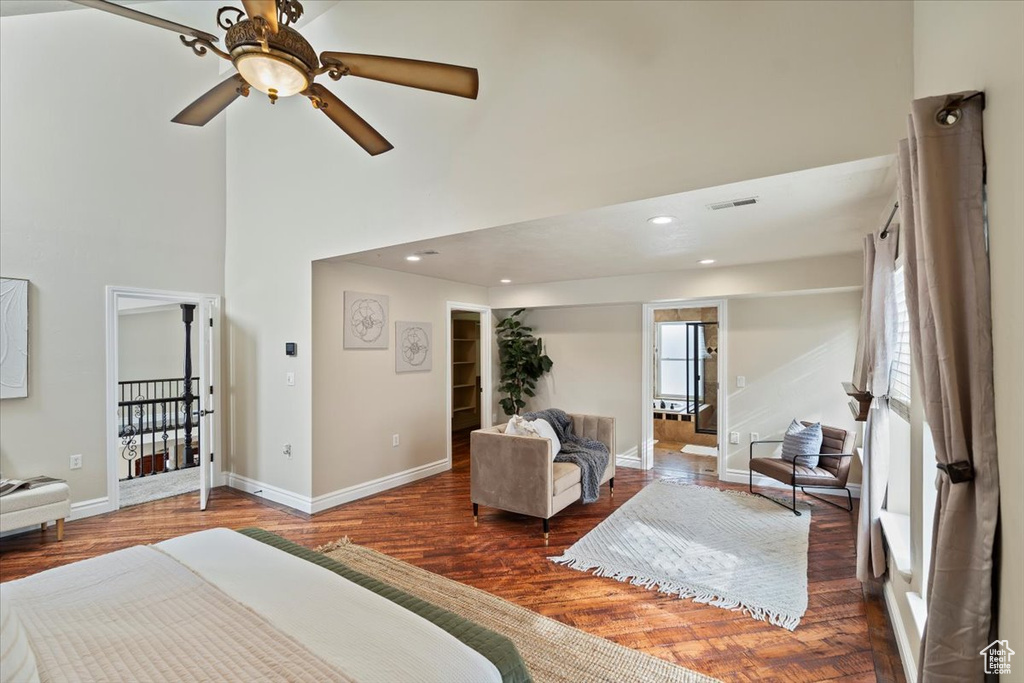 Bedroom featuring wood finished floors, visible vents, baseboards, a high ceiling, and recessed lighting