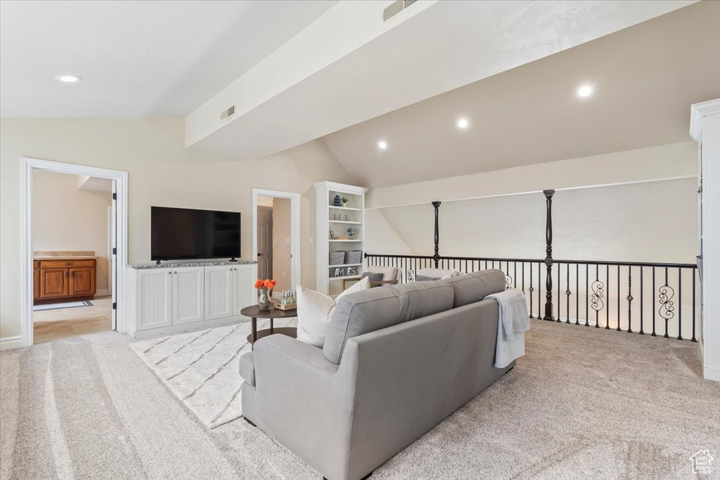 Living room featuring recessed lighting, light carpet, and lofted ceiling