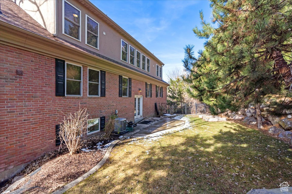 View of yard with central AC unit and a patio area