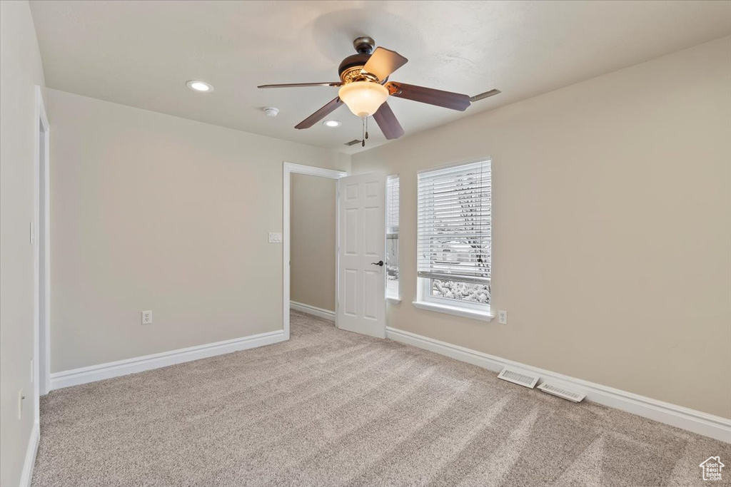 Unfurnished room with recessed lighting, light colored carpet, baseboards, and ceiling fan